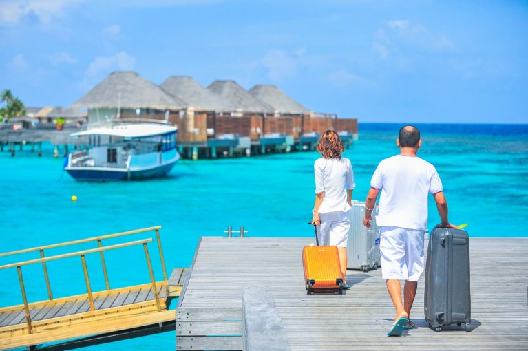 Two people holding bags going to vacation