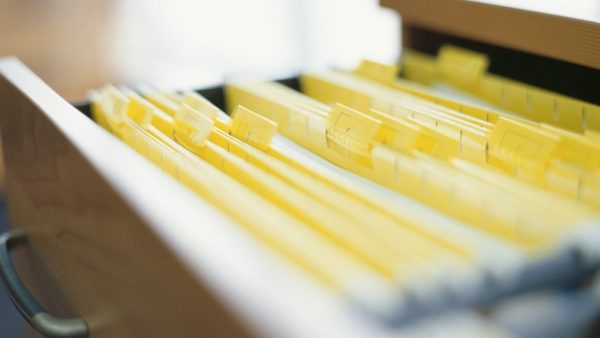 a file drawer filled with yellow folders