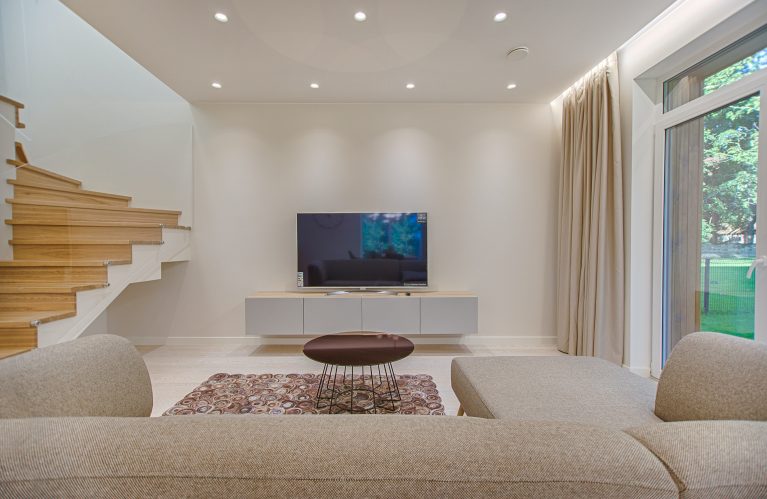 modern home with neutral lounge room and wooden stairs