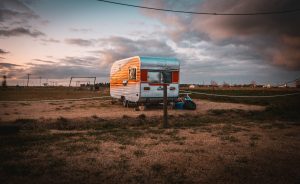 caravan parked out in the open space of a field